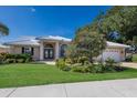Charming single-story home with a well-maintained lawn and garden with meticulous landscaping at 1447 Gleneagles Dr, Venice, FL 34292