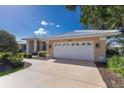 This charming home features a large attached garage and meticulously maintained landscaping at 1447 Gleneagles Dr, Venice, FL 34292