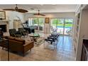 Open-concept living area featuring tile floors, comfortable seating, and sliding doors to the backyard at 173 Bath Club N Blvd, North Redington Beach, FL 33708