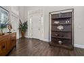 Inviting foyer features beautiful wood floors, display shelving and a glass-paneled front door at 19006 69Th E Ave, Bradenton, FL 34211