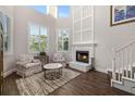 Bright living room with fireplace, soaring ceilings, large windows, and elegant decor at 19006 69Th E Ave, Bradenton, FL 34211