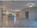 Bright, open-concept living space with tile floors, high ceilings, and modern lighting fixtures at 25 Sabot Ct, Placida, FL 33946