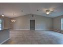 Spacious living area with vaulted ceilings seamlessly connecting to the modern kitchen at 25 Sabot Ct, Placida, FL 33946
