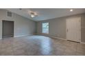 Inviting living area with a large window, neutral color palette, and tile flooring at 25 Sabot Ct, Placida, FL 33946