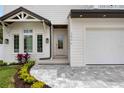 Charming home exterior featuring a well-manicured lawn, walkway, and an inviting entrance with large windows at 2596 Floyd St, Sarasota, FL 34239
