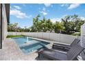 Backyard featuring a refreshing pool with lounge chairs, and a privacy fence for secluded outdoor enjoyment at 2596 Floyd St, Sarasota, FL 34239