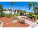 Inviting front yard featuring lush landscaping, a brick walkway, and a well-maintained lawn leading to the entrance at 2816 88Th E Ave, Parrish, FL 34219