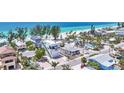 Stunning aerial view of beachfront homes with lush tropical landscaping and breathtaking ocean views at 2918 Avenue E, Holmes Beach, FL 34217