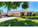 Inviting single-story home featuring a two-car garage, lovely landscaping, and a welcoming entrance at 3007 Live Oak Ln, Palmetto, FL 34221