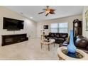 Comfortable living room with tile floors, vaulted ceilings, flat-screen tv, and two plush leather sofas at 3453 Dryden St, North Port, FL 34288