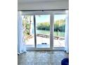 Inviting interior view through sliding glass doors with views of canal front dockage at 36 N Starboard Dr, Venice, FL 34285