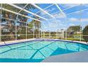 Inviting screened-in pool area with beautiful blue water, perfect for relaxation and entertaining at 4180 Via Mirada, Sarasota, FL 34238