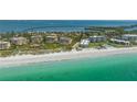 Stunning aerial view of beachside condos on a sunny day with ocean views and beachfront access at 4800 Gulf Of Mexico Dr # 204, Longboat Key, FL 34228