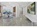 Bright and spacious foyer with marble flooring and stylish decor at 50 Central Ave # 17Phd, Sarasota, FL 34236