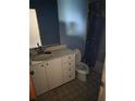 Bathroom with a white vanity, sink, toilet, and blue painted walls at 519 36Th E Ave, Bradenton, FL 34208