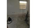 Empty bedroom featuring a window and bare concrete flooring at 519 36Th E Ave, Bradenton, FL 34208