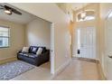 Bright entryway featuring tile floors, high ceilings, and a glimpse into the adjacent living space at 6519 43Rd E Ct, Sarasota, FL 34243