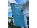 Close up view of property's bright blue exterior with white lettering at 6610 Midnight Pass Rd # 11, Sarasota, FL 34242
