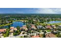 High aerial showcasing a sprawling community with lakes, mature trees, and well-maintained landscaping at 6819 Dominion Ln, Lakewood Ranch, FL 34202