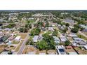 A high angle aerial view shows this charming single story house centrally located within a residential neighborhood at 7141 37Th N Ave, St Petersburg, FL 33710