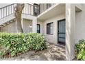 The entrance of the condo has a doormat that reads 'Home Sweet Home', along with tropical plants at 7876 Eagle Creek Dr, Sarasota, FL 34243