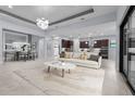 Bright living room featuring contemporary lighting, neutral tones, and an open floorplan at 8229 Grande Shores Dr, Sarasota, FL 34240