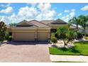 Charming home with three-car garage, brick driveway, and beautifully maintained landscaping at 8297 Barton Farms Blvd, Sarasota, FL 34240