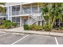 Condo exterior with stairs, balcony, and lush tropical landscaping at 850 S Tamiami Trl # 624, Sarasota, FL 34236