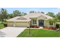 Lovely single-Gathering home featuring a three-car garage, colorful flowerbeds, meticulously kept lawn, and an inviting entryway at 9106 Yarberry St, Sarasota, FL 34240