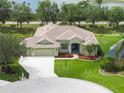 Charming single-Gathering home featuring a well-manicured lawn, three-car garage, mature trees, and a welcoming covered entrance at 9106 Yarberry St, Sarasota, FL 34240