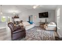 Bright living room with comfortable seating, neutral walls, wood-look tile flooring, and an airy feel at 9601 Calumet Blvd, Port Charlotte, FL 33981