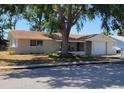 Charming single story home with covered porch and mature shade trees at 9835 El Camino Real Ave, Port Richey, FL 34668