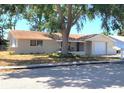 Charming single story home with covered porch and mature shade trees at 9835 El Camino Real Ave, Port Richey, FL 34668