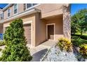 The door and garage to a tan townhouse, with plants on either side at 1033 Grantham Dr, Sarasota, FL 34234