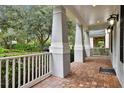 Charming front porch featuring brick flooring and substantial columns for a welcoming curb appeal at 11504 Splendid Ln, Tampa, FL 33626