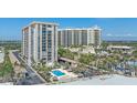 Exterior showcasing condo building with pool, landscaping, and proximity to beaches at 1212 Benjamin Franklin Dr # 306, Sarasota, FL 34236