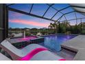 Beautiful pool and spa with lighting, offering relaxation and stunning views of the lake at 12237 Longview Lake Cir, Bradenton, FL 34211