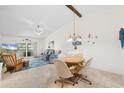 Cozy living room and dining area with vaulted ceilings, neutral colors, and abundant natural light at 1302 58Th W St, Bradenton, FL 34209