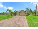 Inviting single-story home featuring a brick driveway, a two-car garage, and meticulously manicured landscaping at 15608 31St E St, Parrish, FL 34219