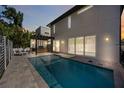 Backyard featuring a stunning pool, outdoor kitchen with grill, and elegant hardscape, perfect for outdoor living at 2590 Floyd St, Sarasota, FL 34239