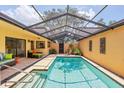 Inviting screened pool with covered lounge area offers a private outdoor retreat at 3955 Glen Oaks Manor Dr, Sarasota, FL 34232