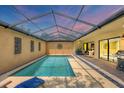 Relaxing screened-in pool area perfect for enjoying the outdoors year-round with sunset sky at 3955 Glen Oaks Manor Dr, Sarasota, FL 34232