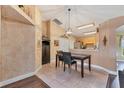 Bright dining area featuring tile floors, decorative walls, and views of the kitchen at 4211 Kingsfield Dr, Parrish, FL 34219