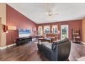 Comfortable living room with hardwood floors, large windows, and a stylish accent wall at 4211 Kingsfield Dr, Parrish, FL 34219