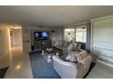 Relaxing living room featuring built-in shelves, comfortable seating, and sliding glass doors to outdoor at 4411 Dolphin Ln, Palmetto, FL 34221
