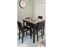 Dining area with modern table, chairs, and a wall clock at 4415 45Th W Ave # 203, Bradenton, FL 34210