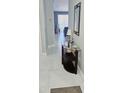 Inviting entryway with tile flooring, stylish console table and grey wall color at 4415 45Th W Ave # 203, Bradenton, FL 34210