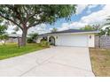 Lovely one-story home showcasing a driveway and an attached garage at 4415 Charing Cross Rd, Sarasota, FL 34241