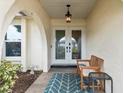 Cozy front porch features a bench, an accent rug, and double entry doors at 4415 Charing Cross Rd, Sarasota, FL 34241