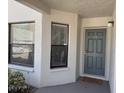 Exterior entryway featuring a gray door marked '101' and two windows that provide natural light at 4505 45Th W Ave # 101B, Bradenton, FL 34210